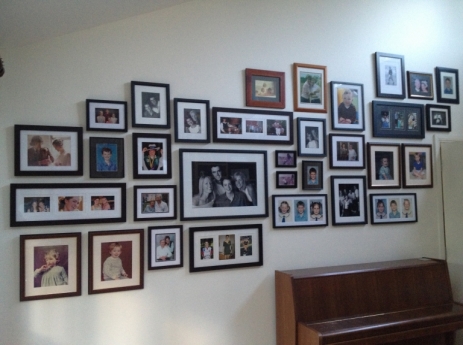 'Rogues' gallery' of family photos on plasterboard wall