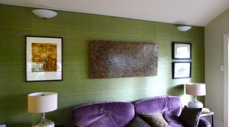 Artwork hung on stainless steel wires off brushed metal tracking